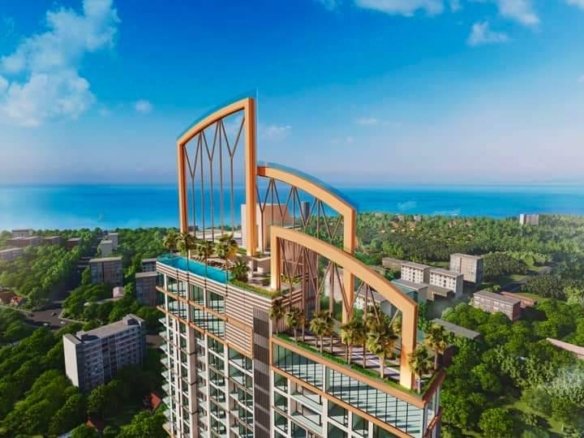 High-rise residential tower with a landscaped rooftop terrace and orange arch structures, overlooking a coastal city and blue sea.