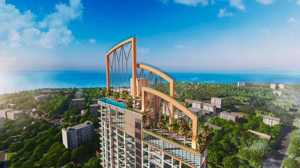High rise residential tower with a landscaped rooftop terrace and orange arch structures overlooking a coastal city and blue sea