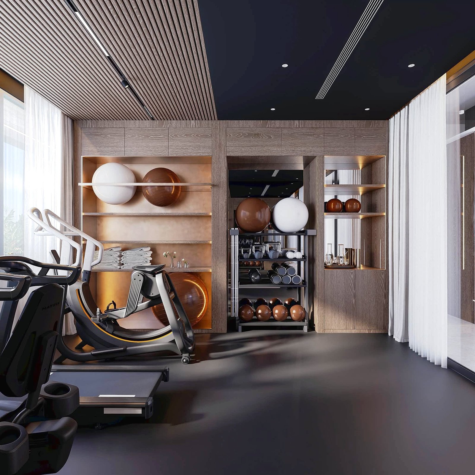 Astera_Villa_Pattaya_13 Modern gym interior with cardio treadmills in the foreground and wooden shelves holding orange and white exercise balls beneath a dark ceiling.