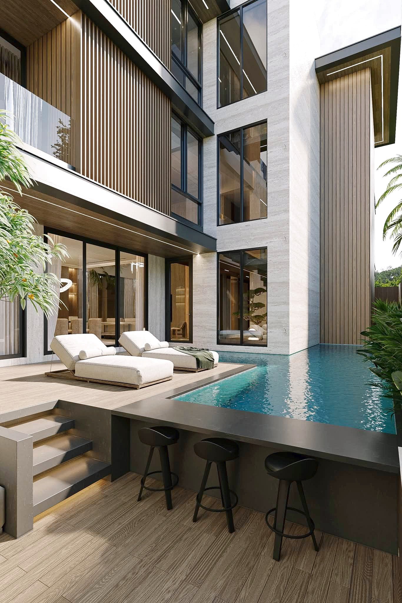 Astera_Villa_Pattaya_15 Modern house exterior with glass walls, wood slats, and a poolside deck with white lounge chairs by the water.
