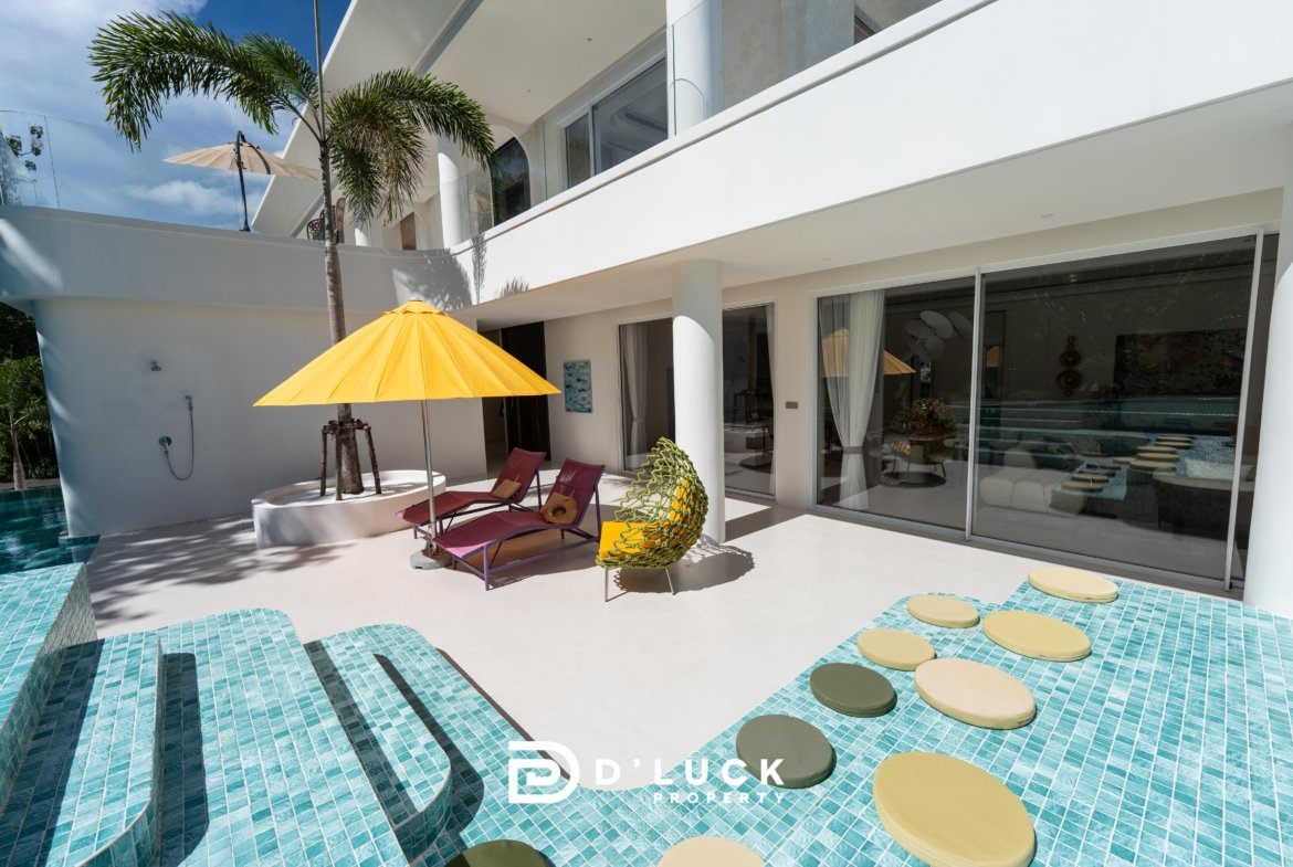 Modern luxury villa pool area with turquoise tiled steps, a bright yellow umbrella, and purple lounge chairs under a blue sky.