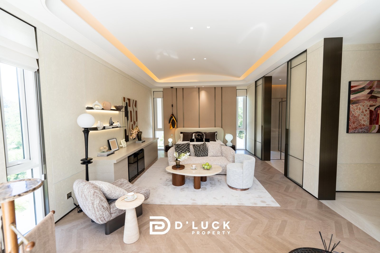 Big_V_Pattaya_Type_A_6 Bright modern living room with beige walls, cream furniture, and round marble coffee table; D’Luck Property logo visible at bottom.