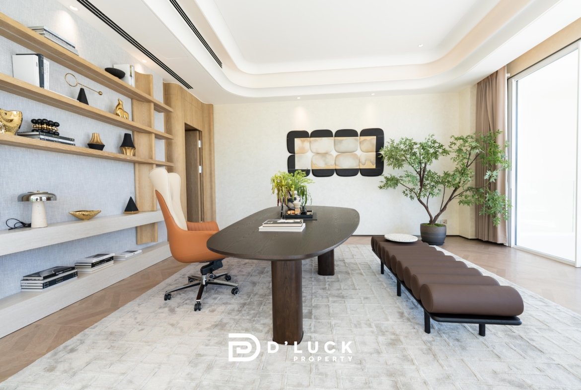 Modern office conference room with wooden shelves, large oval table, orange chair, and potted plants