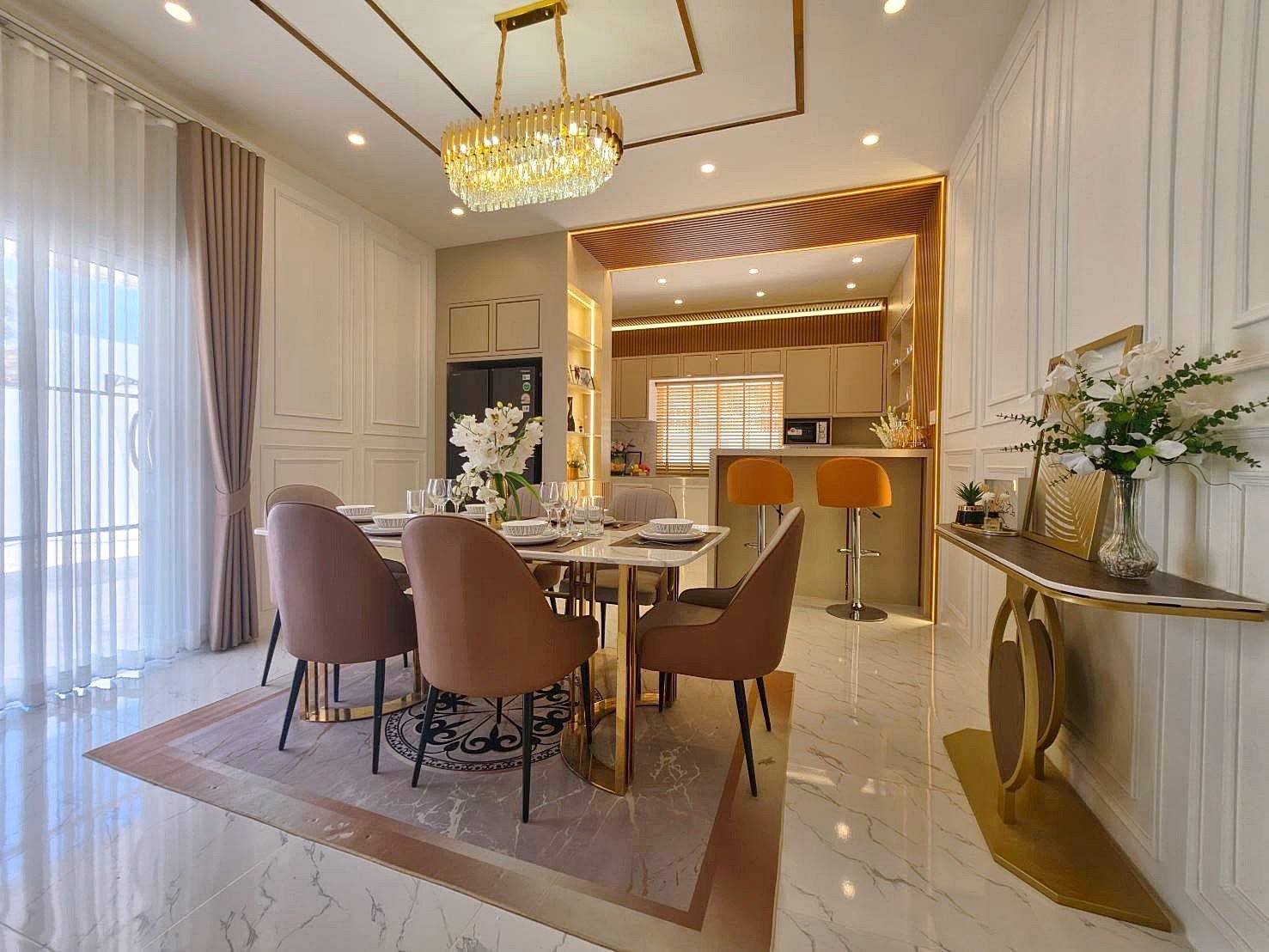 Luxurious dining room with a marble floor, blush chairs, and a gold chandelier over a modern table set for six.