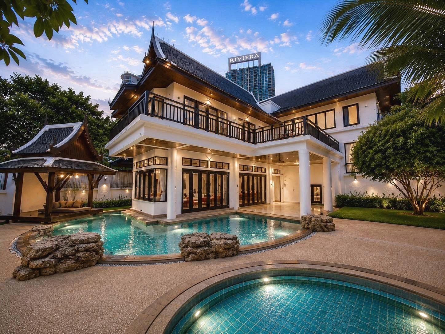 Dharawadi_Poolvilla_Rent_Rdl353 Two-story resort villa with dark wooden railings, large glass doors, and a turquoise pool in a tropical setting.