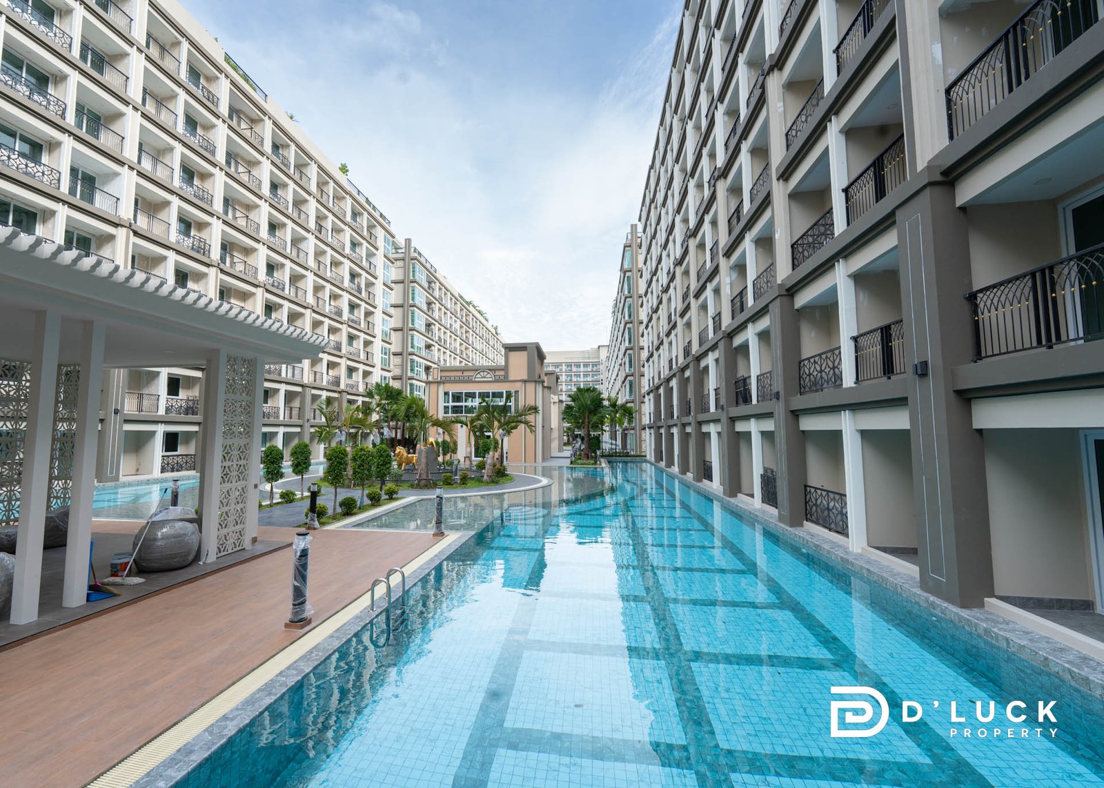 Dusit Grand Park 2 3 Modern residential complex with a long rectangular pool between high-rise buildings and balconies on both sides.