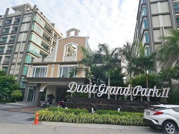 Entrance to Dusit Grand Park II residential complex with palm trees and modern buildings