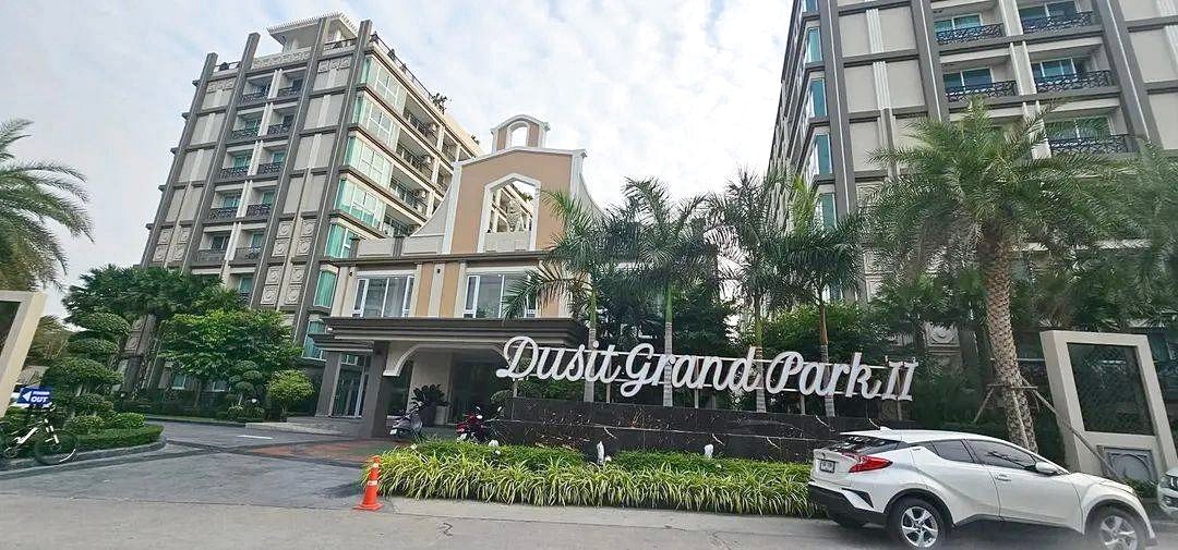 Entrance to Dusit Grand Park II residential complex with palm trees and modern buildings