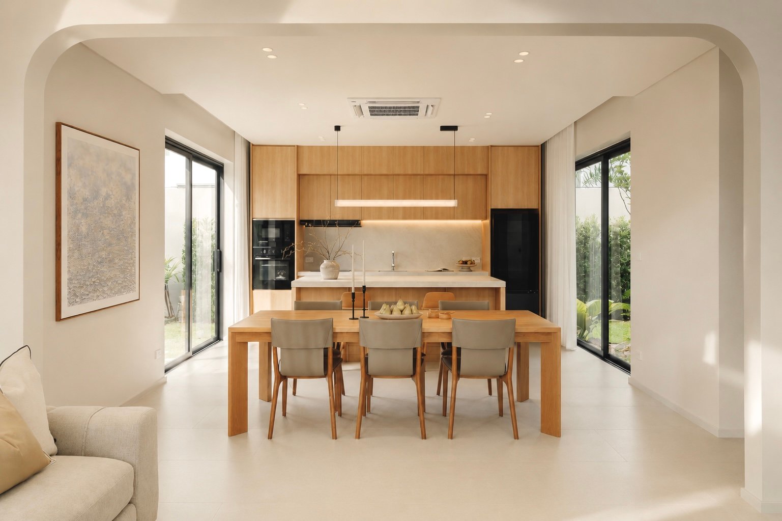 Open-plan kitchen and dining area with a wooden table and six beige chairs, light wood cabinets, and large sliding glass doors to the garden.