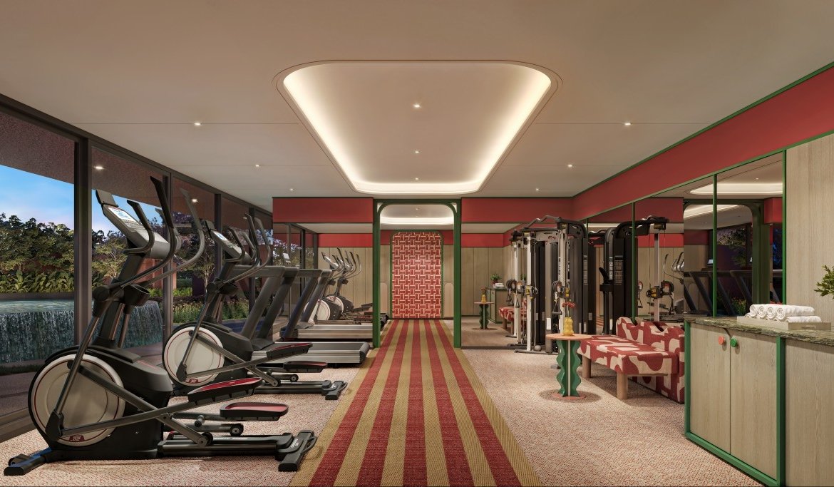 Luxury hotel gym with treadmills along a glass wall overlooking a garden exterior.