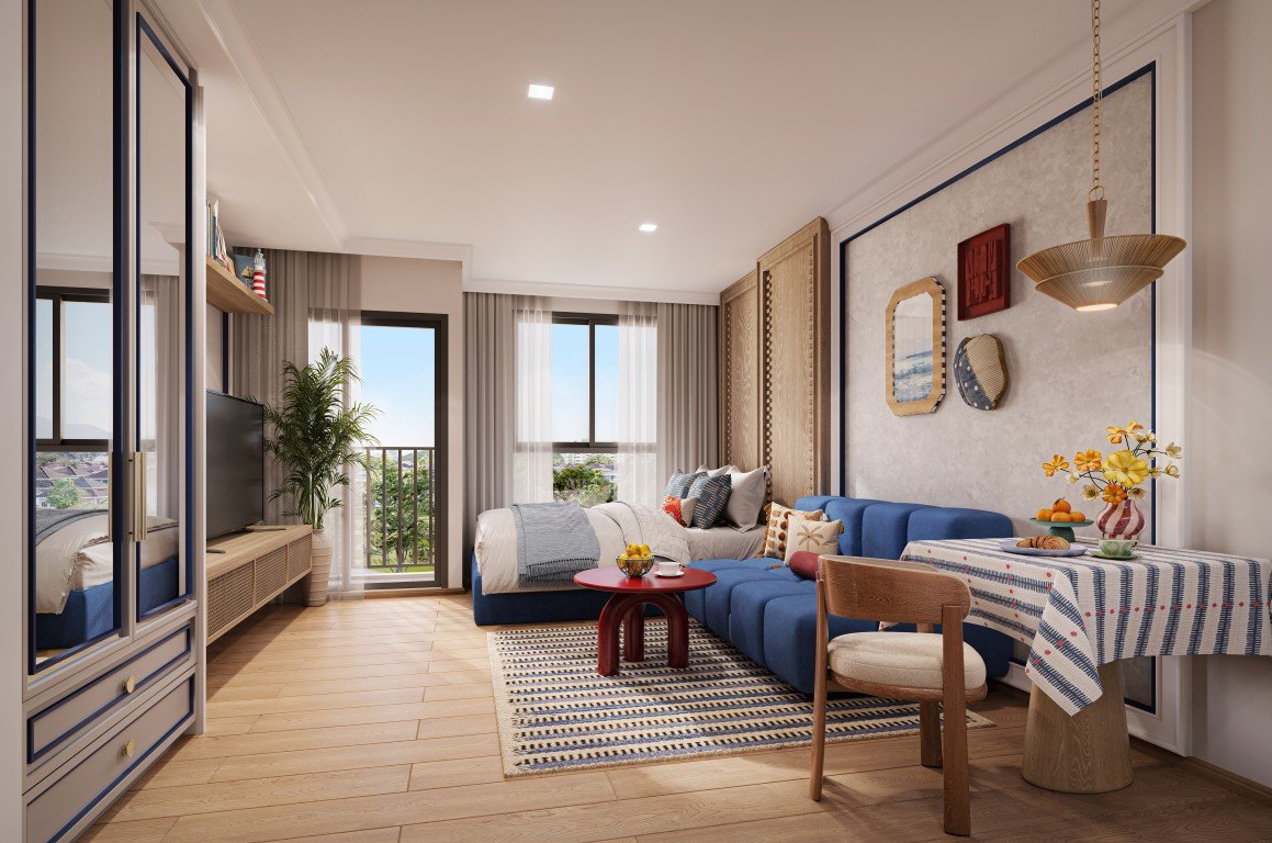 Bright living room with a blue sectional sofa, light wood floors, and a small red coffee table by a striped rug.