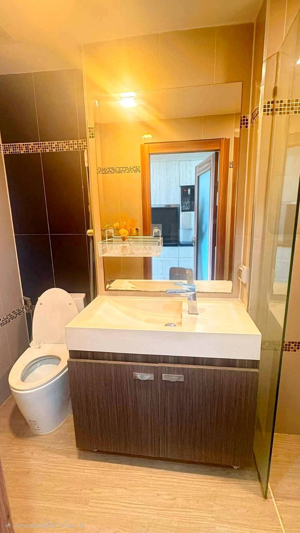 Laguna_2_Pattaya_Sale_Dlc644_13 Bathroom with a dark wood vanity, white rectangular sink, and large mirror; toilet visible on the left.