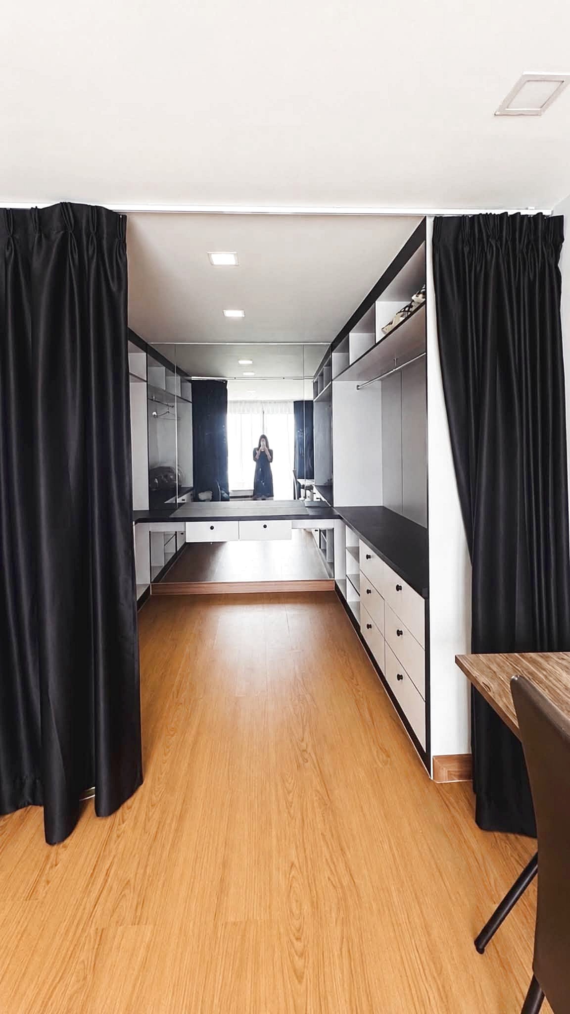 Laguna_2_Pattaya_Sale_Dlc644_4 Long dressing room with wooden floor, black curtains, and a mirrored wall; a person is taking a photo in the distance.