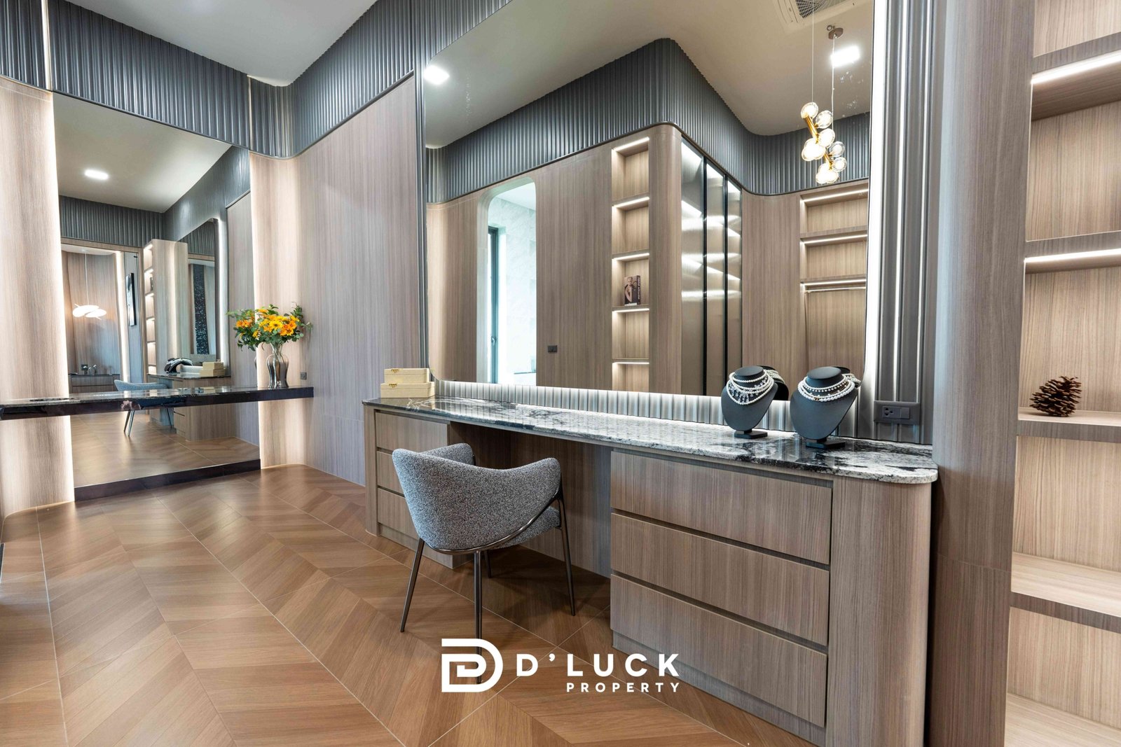 M-Mountian-M3 39 Luxurious jewelry showroom interior with wood display cabinets, marble counter, and mirrored walls displaying necklaces and lights. The 'D'LUCK Property' logo appears at the bottom.
