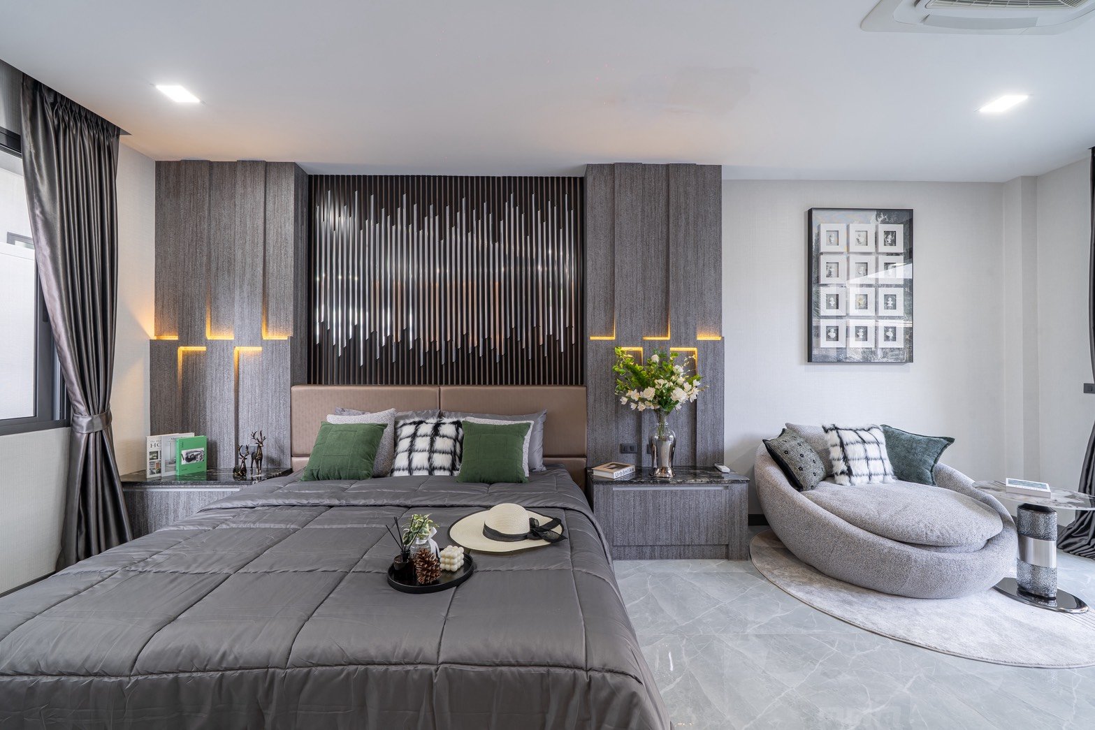 M_Mountain_Dlh518 11 Modern gray bedroom with a tufted headboard, vertical panel wall, two nightstands, and warm accent lighting.