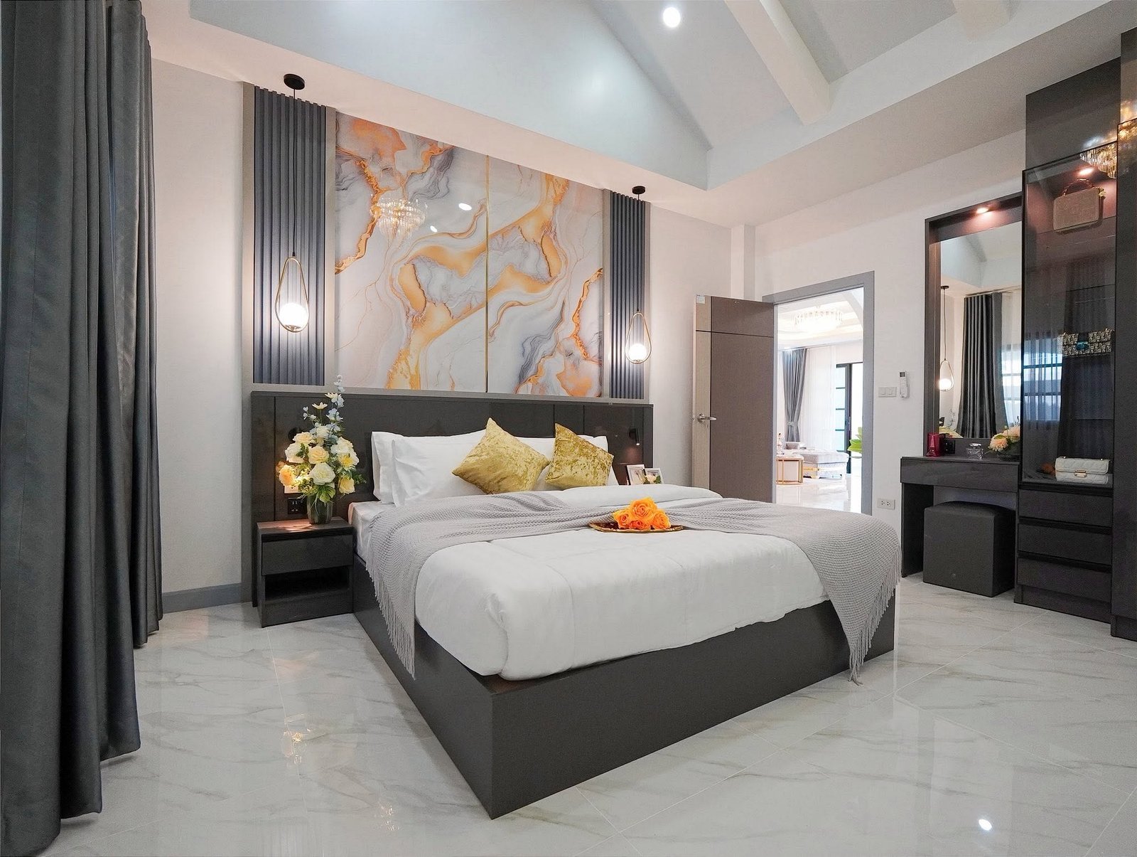 Mabprachan_Village_Pattaya_Dlh564_14 Modern hotel bedroom with a dark wood platform bed, marble accent wall, and gray bedding with yellow cushions.