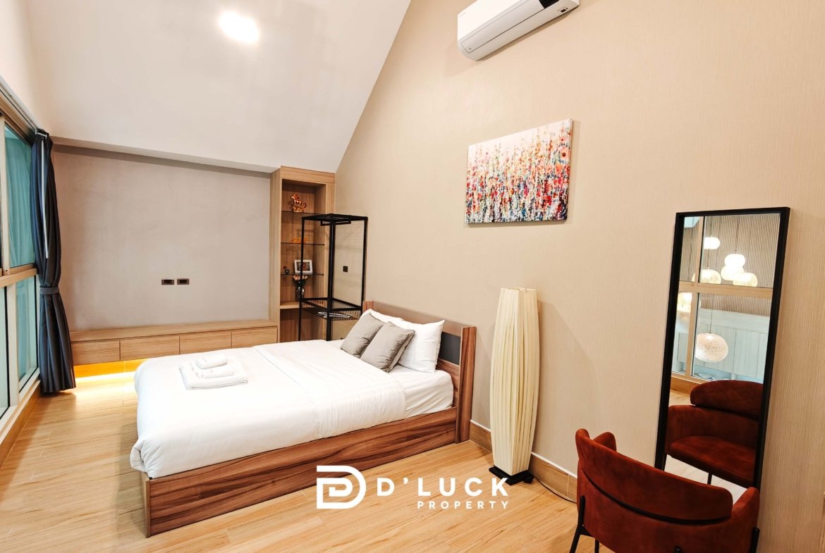 Contemporary bedroom with a wooden bed, built-in cabinet, floor-to-ceiling windows with blue curtains, and an abstract painting on the wall.