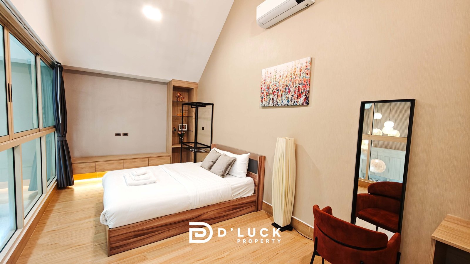 Contemporary bedroom with a wooden bed, built-in cabinet, floor-to-ceiling windows with blue curtains, and an abstract painting on the wall.