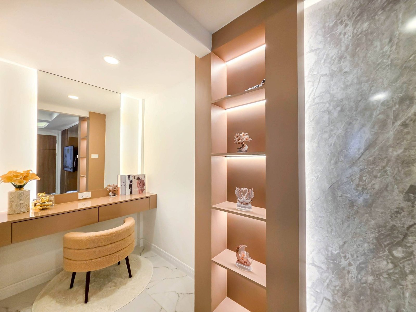 Pool_Villa_South_Pattaya_Sale_Dlh498_6 Modern vanity with a long beige counter, round stool, and a tall backlit shelf unit displaying small decor against a marble wall on the right.