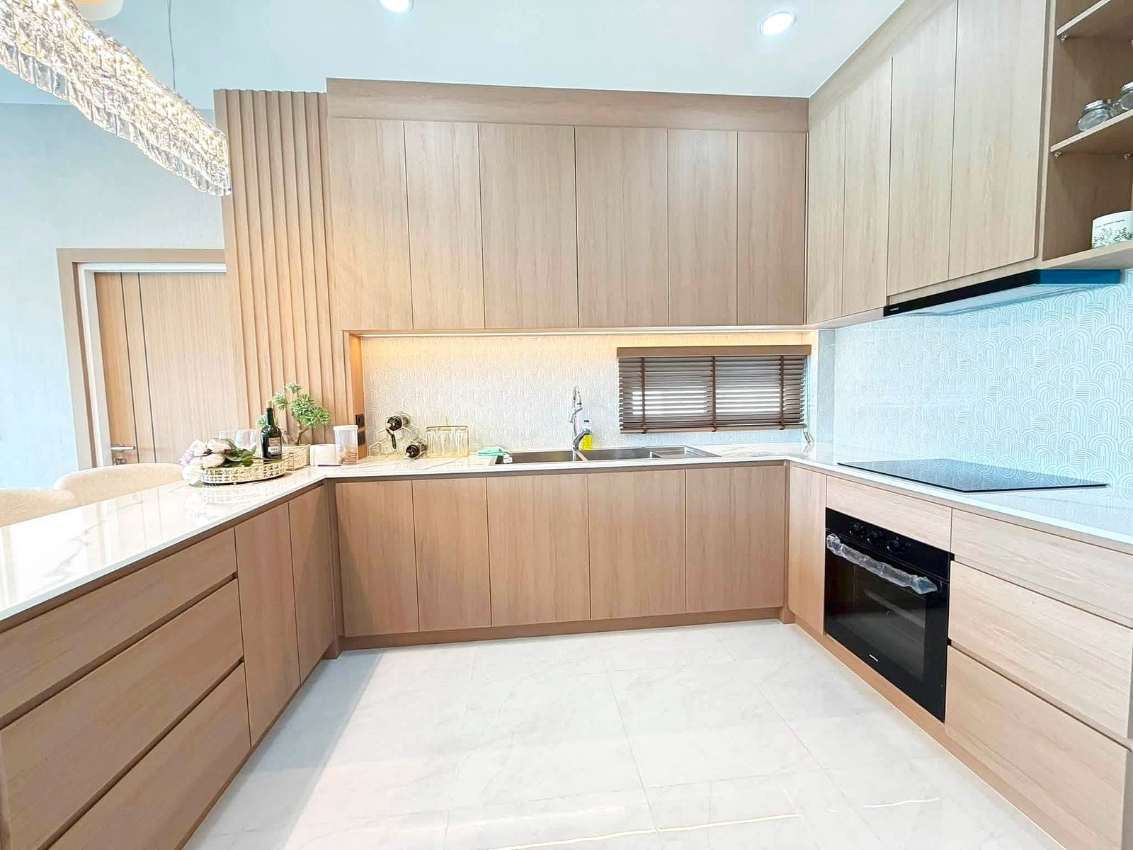 Poolvilla_Khaomakok_Pattaya_Dlh583_13 Modern L-shaped kitchen with light wood cabinets, marble countertops, and built-in oven on the right.