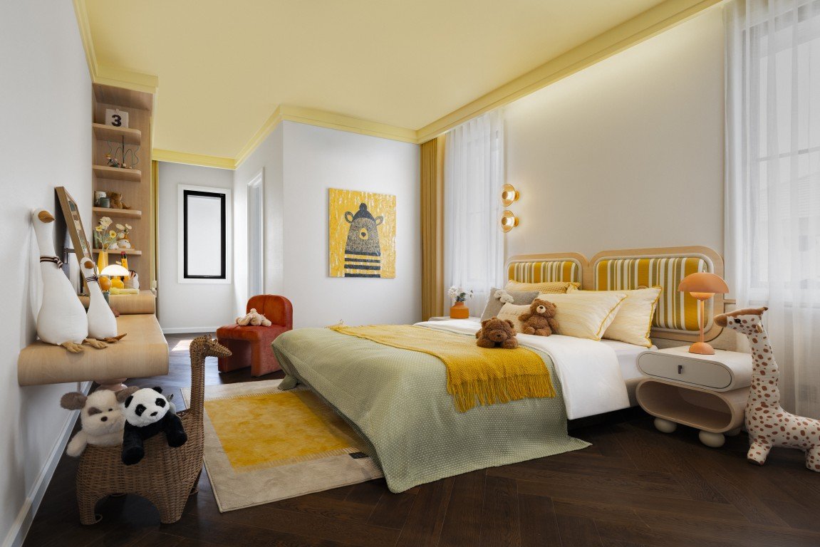 Child's bedroom with yellow-cream decor, bed with stuffed animals, and a giraffe lamp by a sunny window.