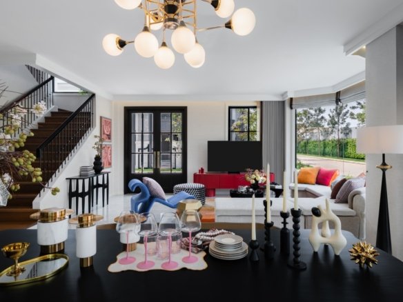 Open living and dining area with a modern chandelier, staircase on the left, and a table set with glasses and candles in the foreground.