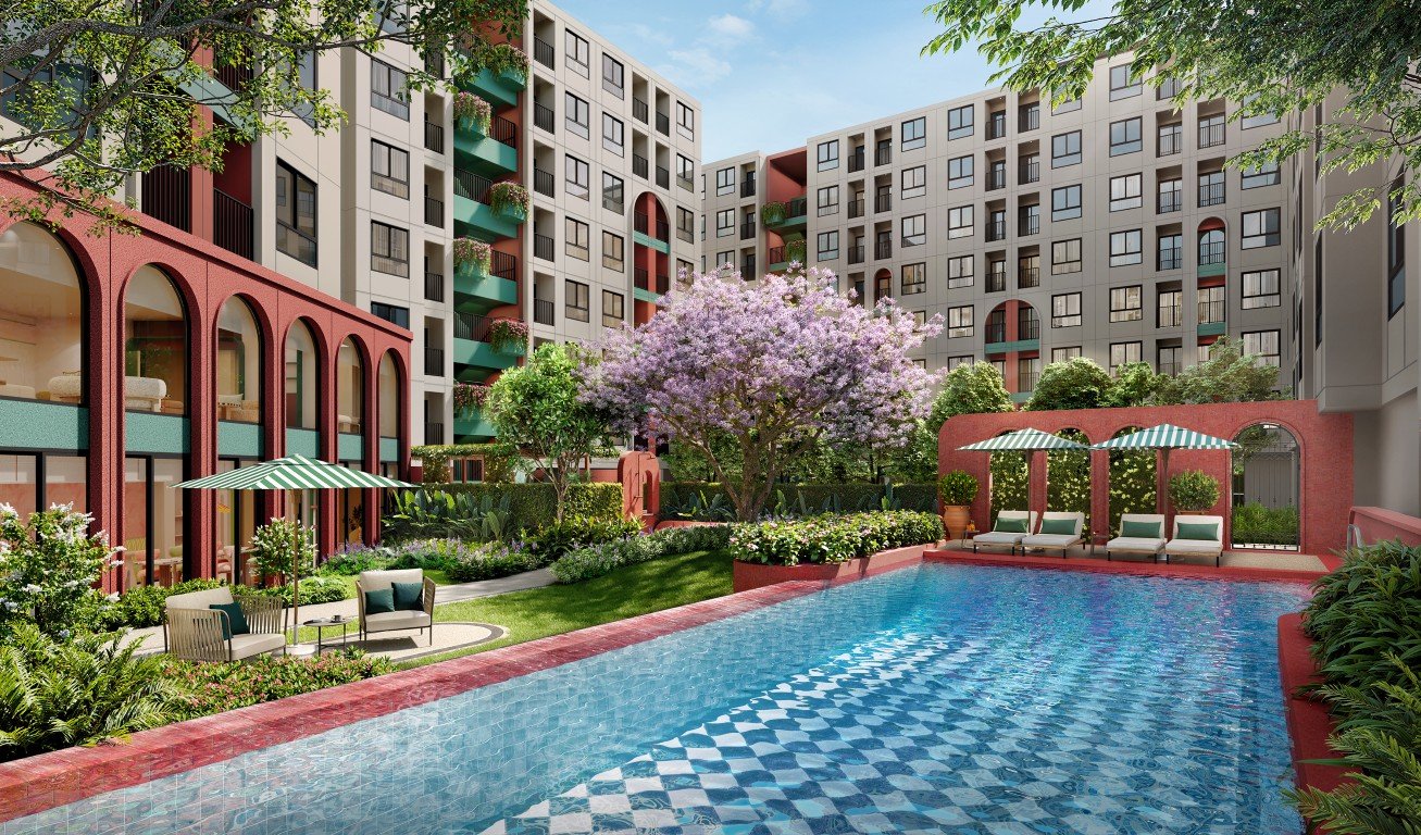SWIMMING_POOL_FINAL Poolside in a colorful apartment complex: blue tiled pool, striped umbrellas, and lounge chairs set among green landscaping and red arches.